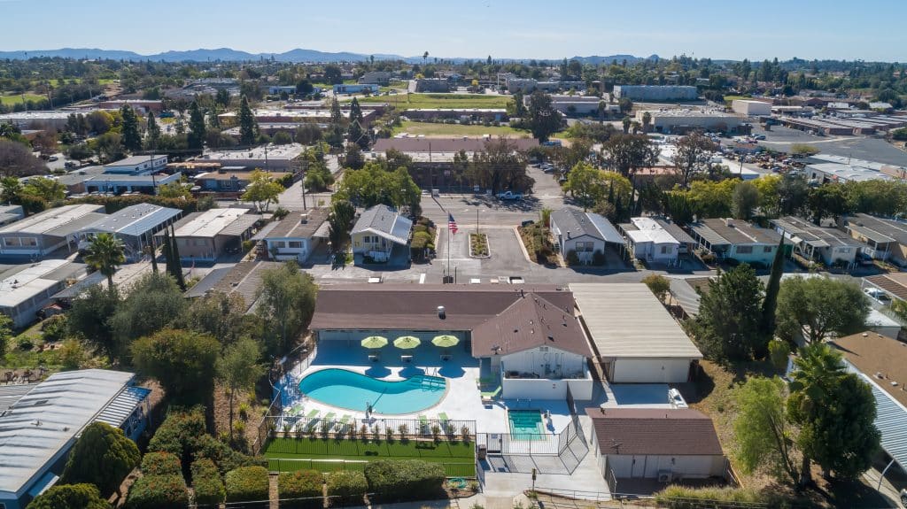 Aerial view of manufactured community houses in Fallbrook California featuring the outdoor swimming pol in the center.